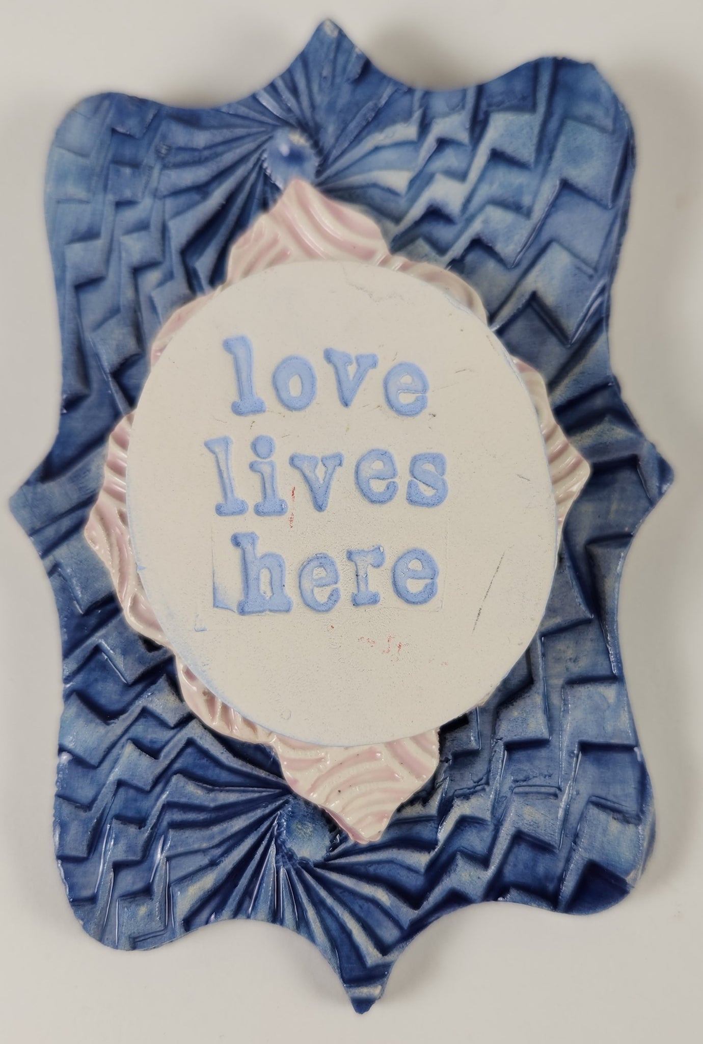 "Love Lives Here" word plaque