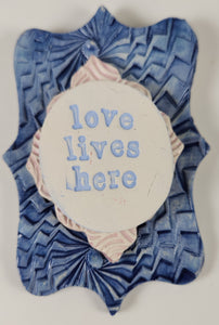 "Love Lives Here" word plaque